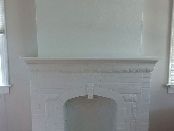 Charming decorative fireplace with mantel perfect for displaying photos & decorative items.