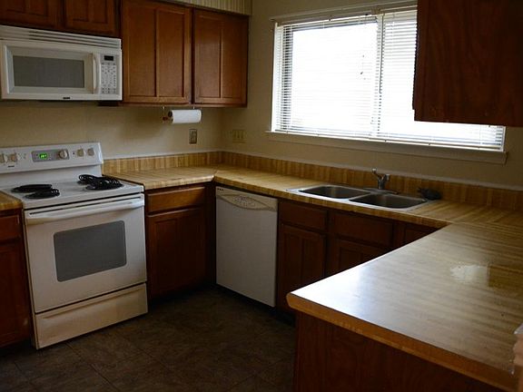 Great kitchen with lots of counter space. Butcher block laminate counter tops and white appliances.