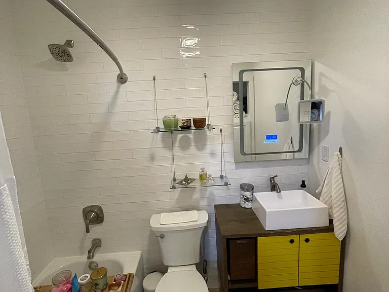 bathroom with tub and good storage