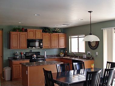 Kitchen has maple cabinets, kitchen island and pantry.
