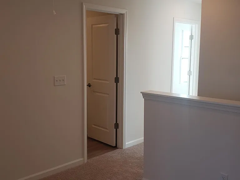 Upstairs hallway at top of stairs. Carpet all upstairs except bathrooms.