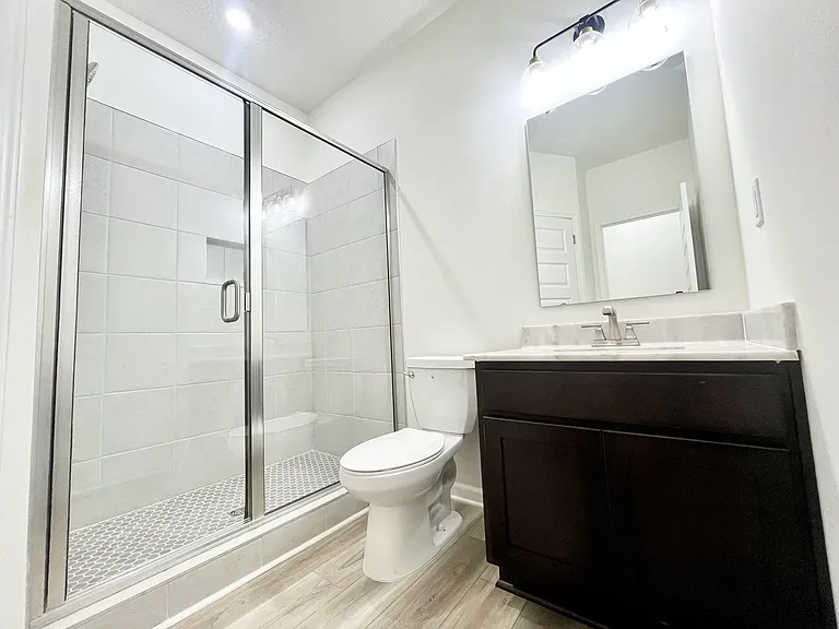 Tile shower with glass door and granite tops