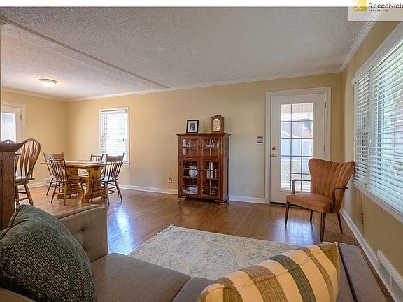 Living room flows smoothly to dining room with gorgeous hardwood floors throughout.
