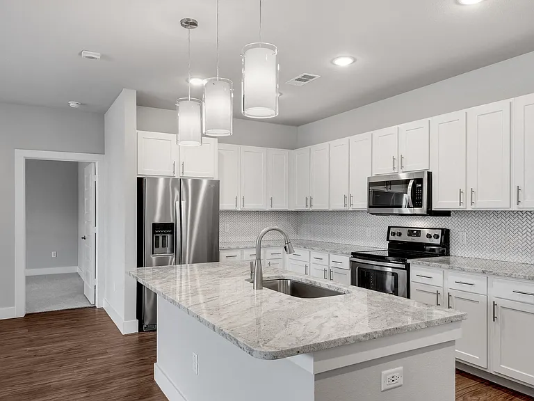 Modern kitchens with stone counter-tops and tile back-splash.
