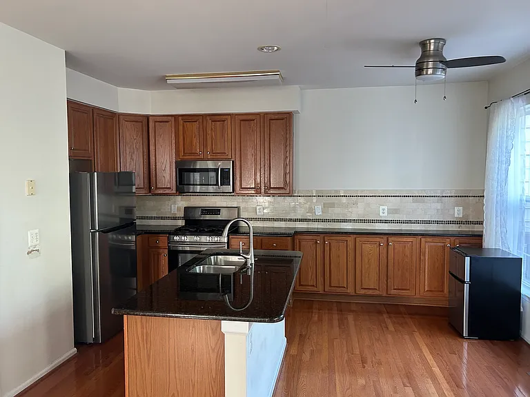 Kitchen with granite countertop and stainless steel appliances