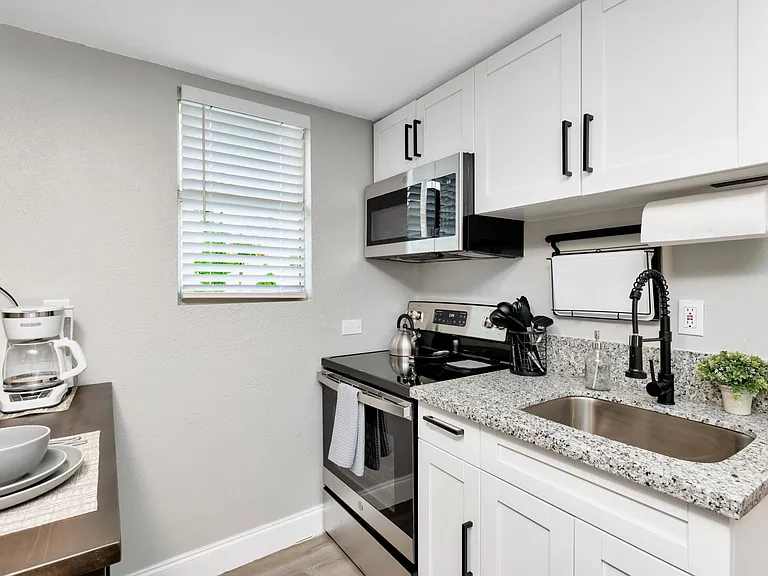 Brand New Stainless Steel Appliances & Granite Countertops; Conveniently placed wall mounted dish drying rack