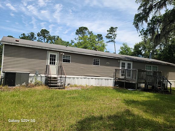 Back of home with deck