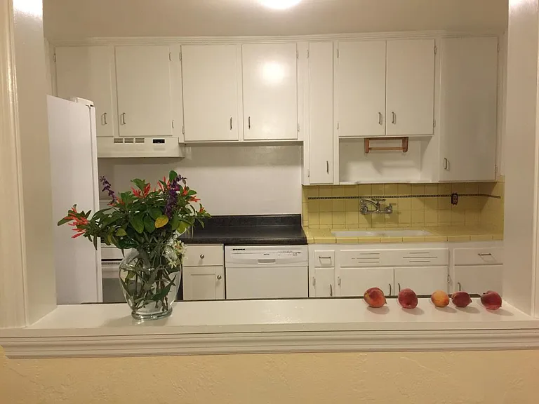 Looking at the kitchen through the pass-through window in dining room