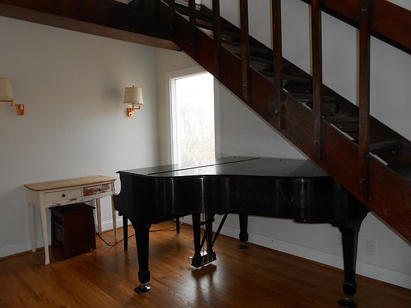 Piano under stairs in Living Room