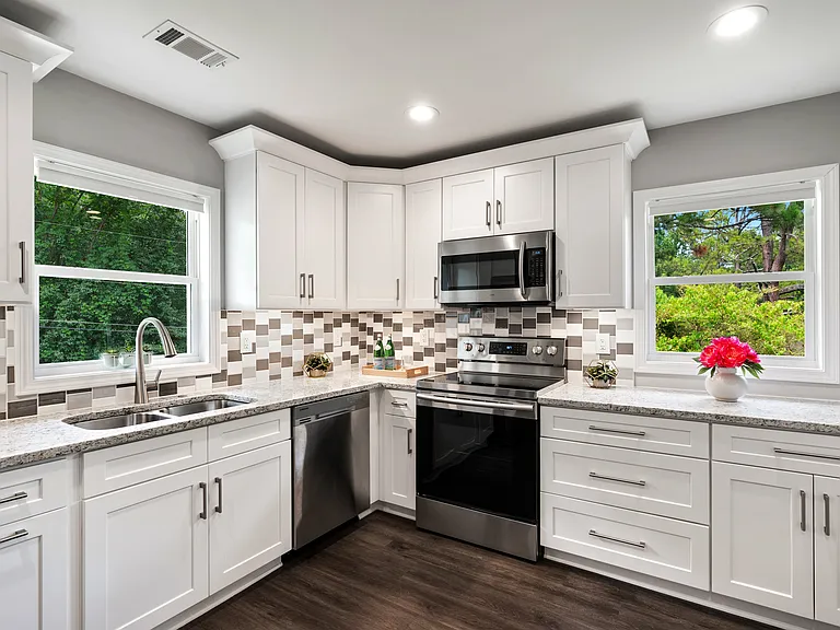 Beautiful, bright, modern, brand new kitchen with SS appliances, granite counters, and white shaker cabinets.