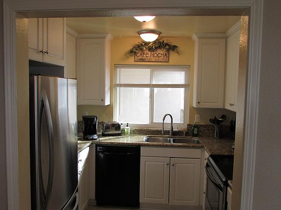 fully stocked kitchen with granite countertops