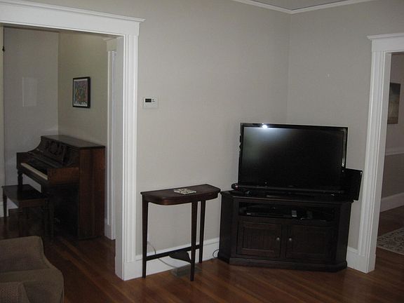View from living room back to front entry hall on left and dining room on right.