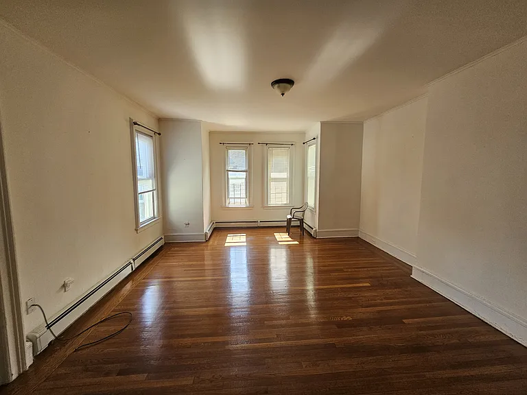 Living Room View 1 - Furniture is not included, chair is only for reference.