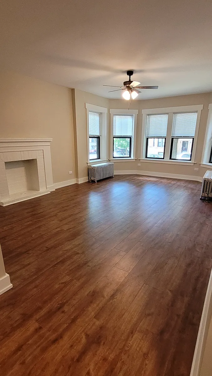 Spacious Living room. Dining table goes very well up in the bay. - 2057 W Arthur Ave