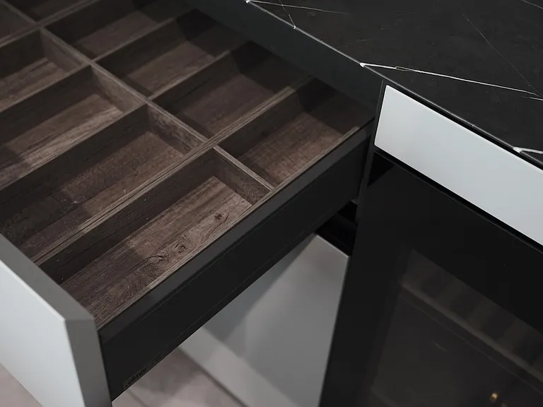Sleek Built-In Shelving with Contrasting Finishes _ This integrated shelving system features a bold contrast between matte black panels and brushed metal accents.