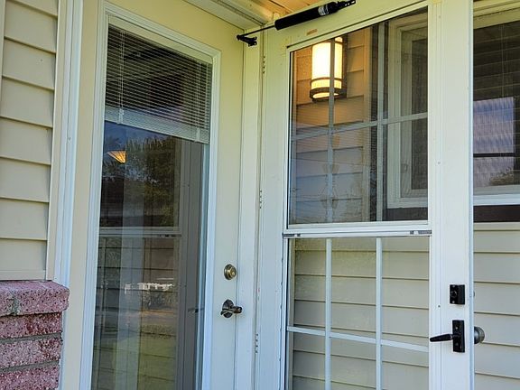 Front door has built-in blinds and is accompanied by a storm door as well. Both have lots of glass for extra light and an additional view of front yard from living room.