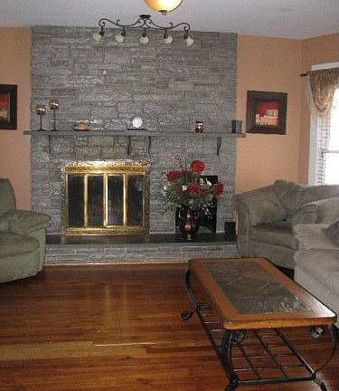 Hardwoods floors and dramatic stone fireplace creates a cozy family room