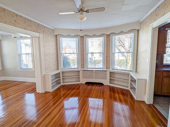 Spacious dining room with charming built-in bookshelves, offering flexibility for hosting or a dedicated home office setup