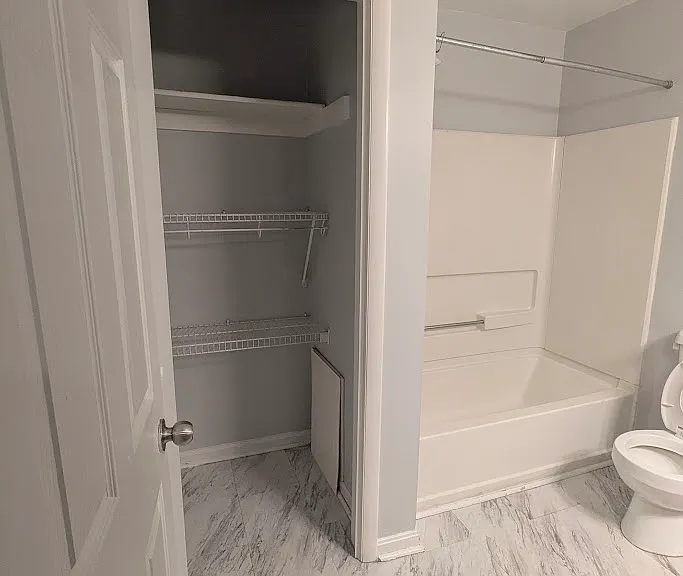 Restroom featuring shelf and bath