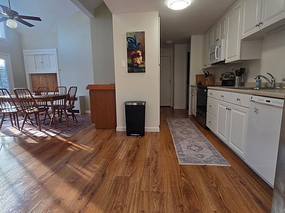Huge dining area and galley kitchen with plenty of storage, cathedral ceilings and gorgeous French doors that lead out to your own private deck overlooking fields and private back yard