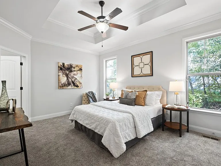 Master bedroom on main level with high coved ceilings and fan. 2nd closet in main room area.
