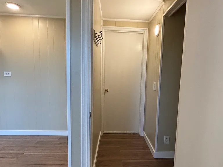 Hallway going to the furnished washer and dryer