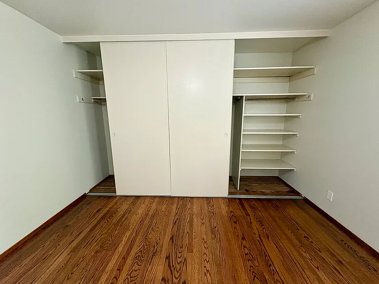 Built-in shelving in bedroom closet