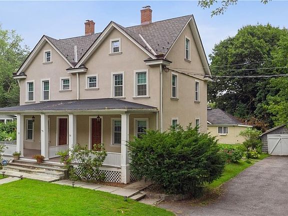 Front of Structure - View of front facade featuring a porch, an outbuilding, and a front lawn
