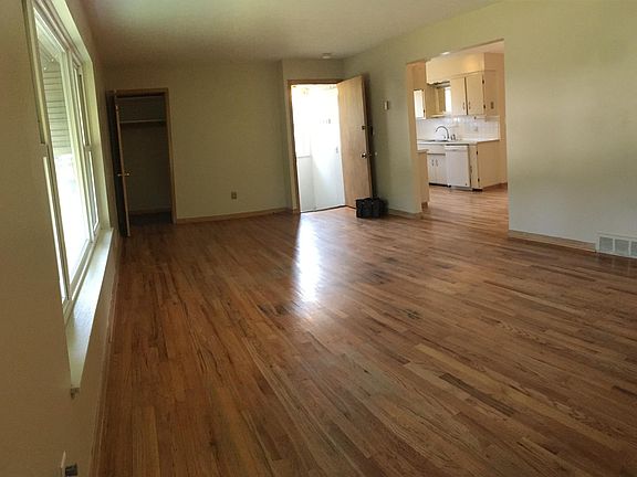 Living Room left to right: coat closet, entrance door, and entry to kitchen area.