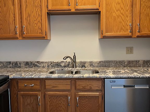 The efficient kitchen has been updated with granite countertops and stainless steel appliances.