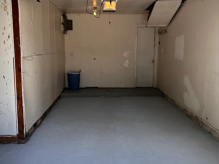 One car garage with side storage area.