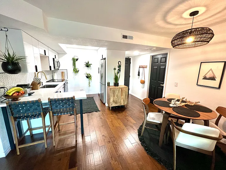View towards Kitchen, Dining Area and Entryway (For Inspiration Only; Comes Unfurnished, these are the old floors)