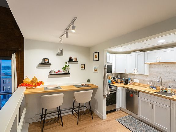 Recently remodeled kitchen with stainless appliances, butcher block counters, undercounter lighting and overhead lighting