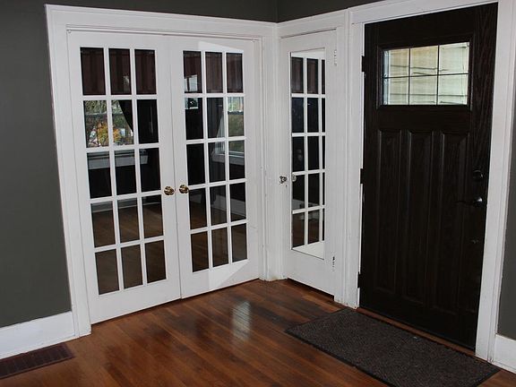 Bedroom 1 has french doors with roman shades for privacy.