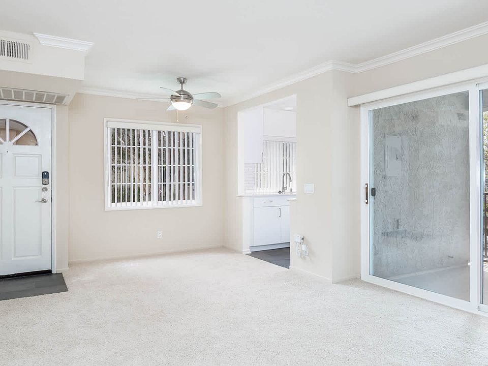 Carpeted Living Room with Balcony