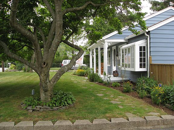 lovely front yard with flowering trees and perennials