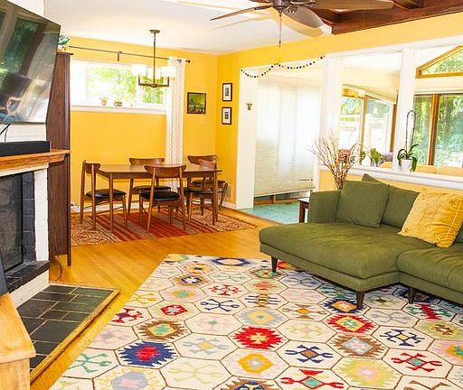 Living room opening to dining area and sunroom