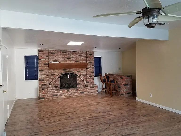 Spacious family room with gas fireplace and bar area with sink!