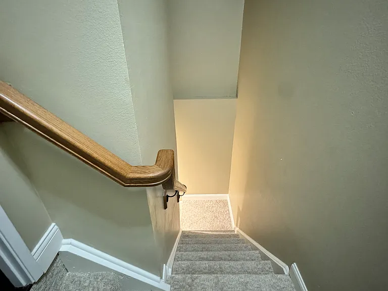 Stairs w custom oak handrail to lower level