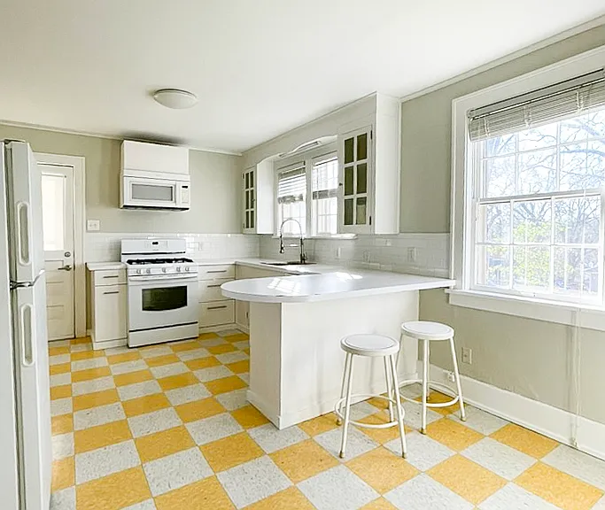 Large kitchen with modern appliances, dishwasher, and garbage disposal.