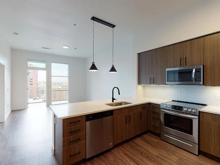 Apartment living room with wood-style flooring and balcony or patio.