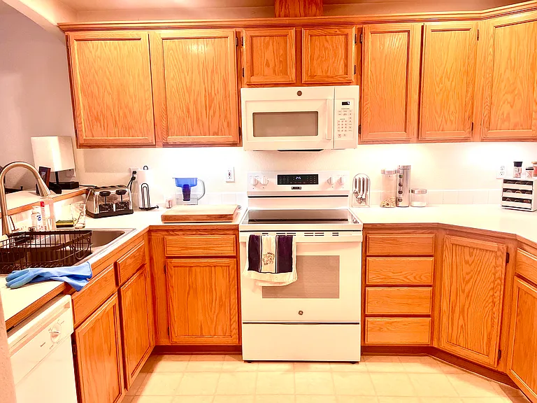 The kitchen is a chef's delight, offering plenty of cabinet space to keep you organized. It comes fully equipped with a refrigerator, electric stove, dishwasher, and a bright, brand-new microwave oven, making meal prep and cleanup a breeze.