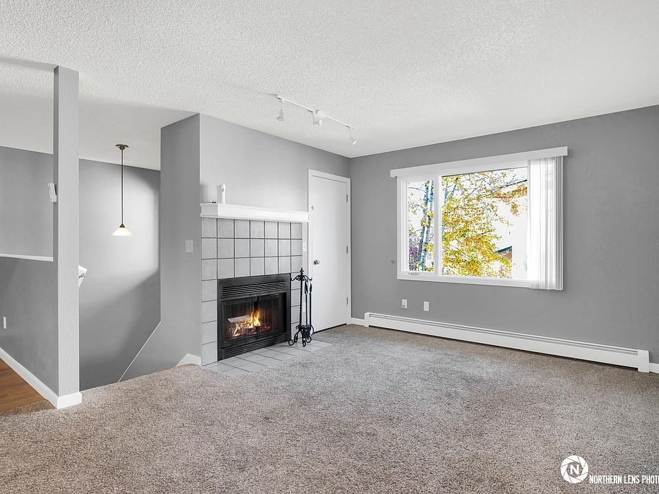 Living room, fireplace (real!) and balcony access