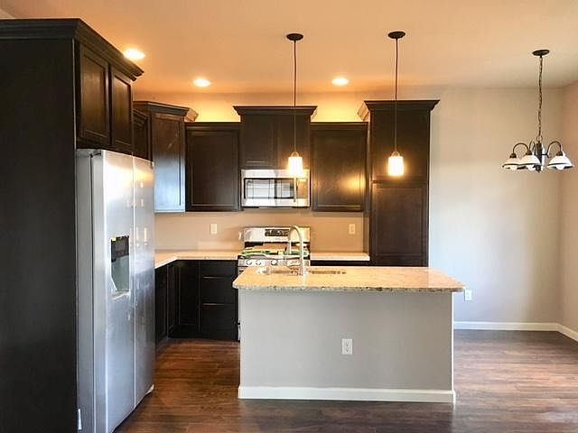 Kitchen with 36" cabinets, SS appliances, granite counter tops and breakfast nock