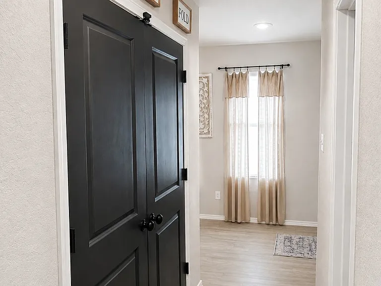 Laundry room located in hall across from guest bathroom