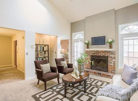 The vaulted great room features two skylights, wood burning fireplace and access to the deck