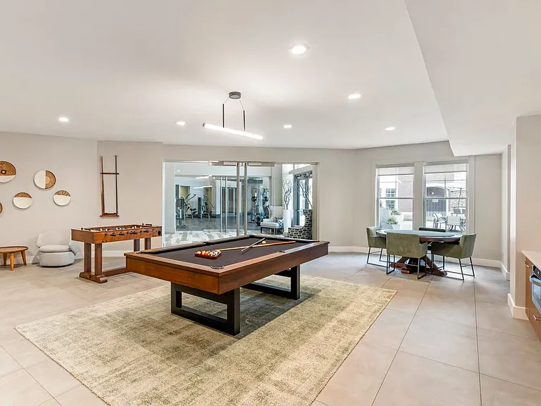 Resident lounge game room with billiards and foosball