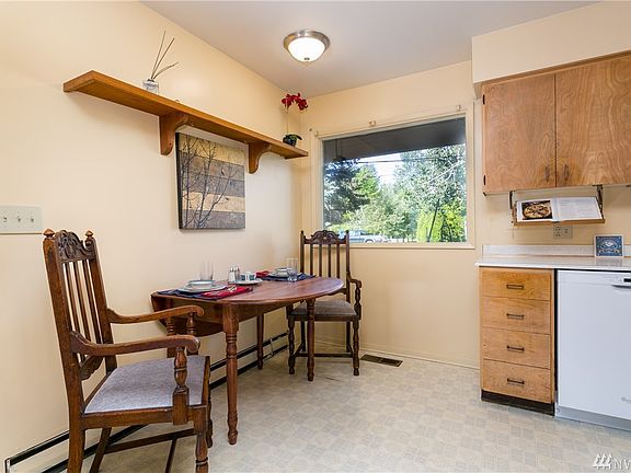 The updated paint adds warmth and brightness to this eat-in kitchen.