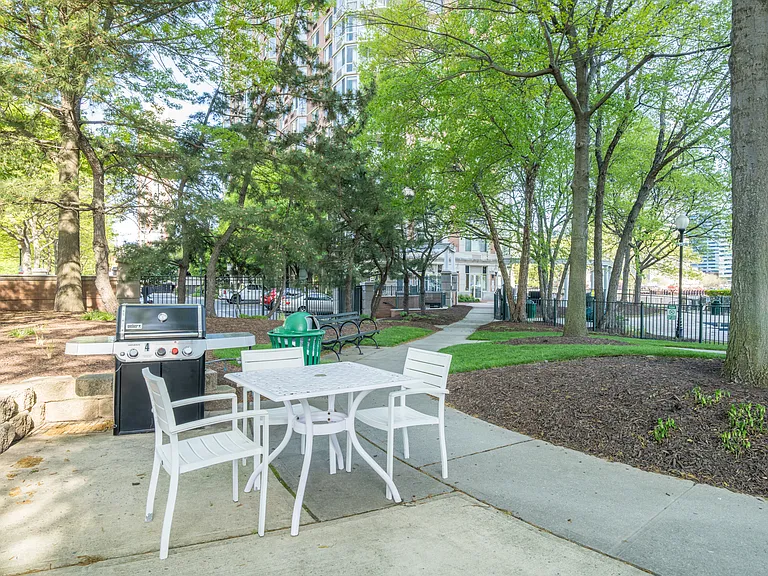 Seating by poolside with grills for residents