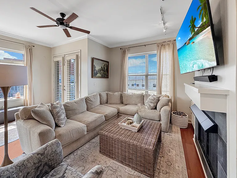 Living room with large window overlooking downtown. Gas fire place and mantle perfect for mounted TV. New remote control fan